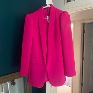 Express Woman’s neon pink blazer with puffed shoulder.